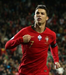 Christiano Ronaldo wearing his red Portugal Jersey bearing a number seven.